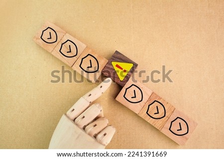 wooden square with caution and safety icons. safety concept in industry Royalty-Free Stock Photo #2241391669