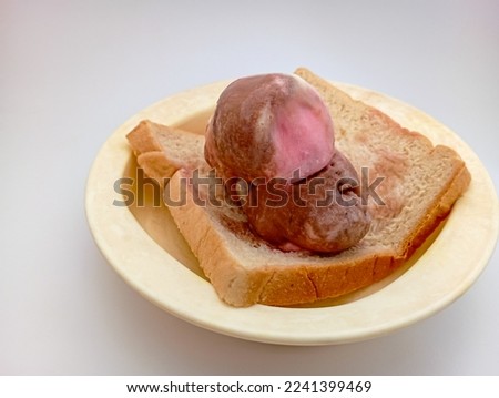 ice cream and a slice of bread on a white background
