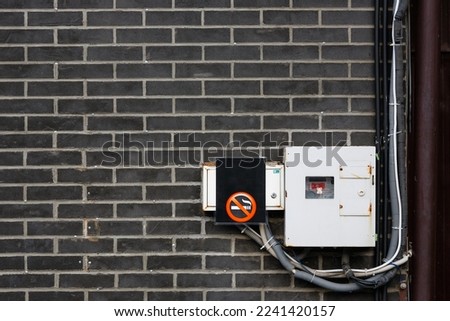 Digital electricity meter. An electricity meter on the wall and a no smoking sign. Concepts of electricity consumption and audit of electricity consumption.