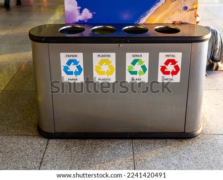 A photo of garabge container encouraging to waste sorting. Different colours means differet kind of garbage. 