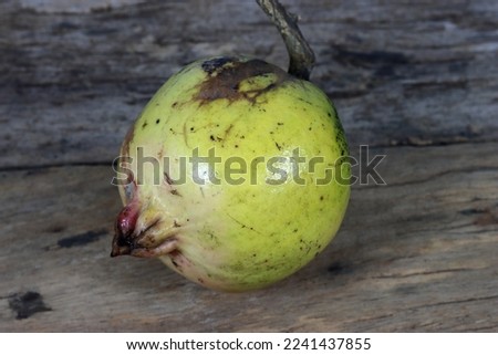 Fresh pomegranate close up picture on the wooden background. Healthful natural fruits for cancer patient