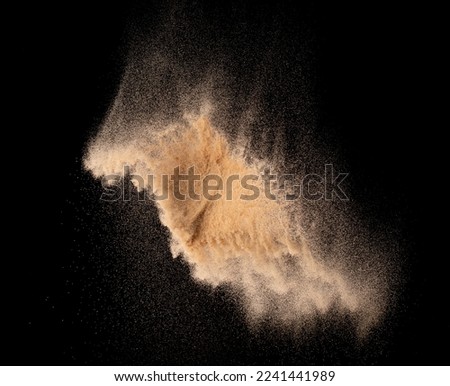 Small size fine Sand flying explosion, Golden grain wave explode. Abstract cloud fly. Yellow colored sand splash silica in Air. Element Black background Isolated high speed throwing freeze shot Royalty-Free Stock Photo #2241441989