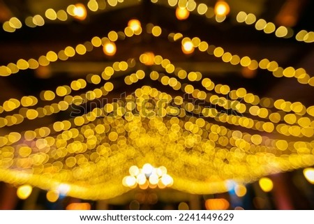 Bokeh decorates the party with many beautiful gold stars lined up in curved lines hanging from the ceiling