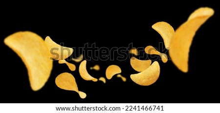 Flying delicious potato chips, isolated on black background Royalty-Free Stock Photo #2241466741