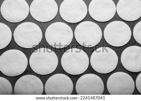 Many clean cotton pads on grey background, flat lay