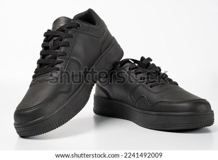 Black shoes isolated on white background. A pair of black sneakers. Royalty-Free Stock Photo #2241492009