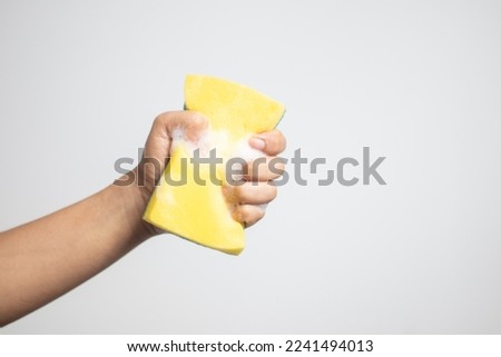 hand holding a sponge with a bubble Royalty-Free Stock Photo #2241494013