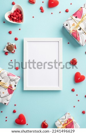 Valentine's Day concept. Top view vertical photo of photo frame gift boxes heart shaped saucer with sprinkles candies and candles on isolated pastel blue background with empty space