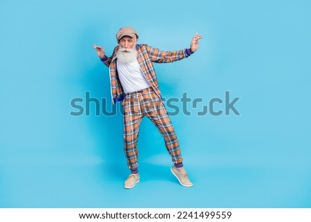 Full length photo of carefree positive senior man wear vintage stylish costume relax nightclub feel young isolated blue color background