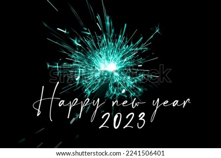 Happy new year 2023 turquoise sparkler new years eve countdown. Luxury entertainment celebration turn of the year party time. Premium nightlife visual with glowing light sparks on dark background