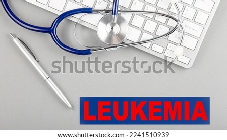 LEUKEMIA word with Stethoscope on a keyboard on grey background
