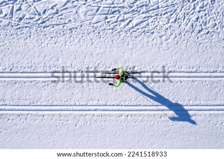 Winter sports competitions, cross country skis glide on fresh snow, aerial top view.
