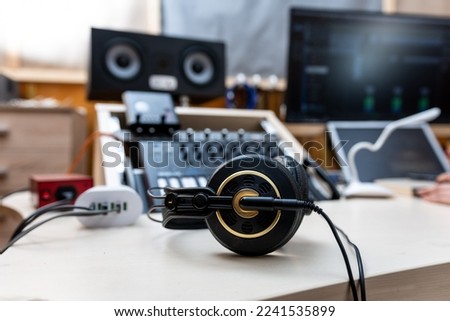 Old professional headphones on the table in the recording studio Royalty-Free Stock Photo #2241535899