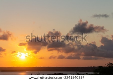 Idyllic sunset in a lagoon with some clouds in the sky. Holiday landscape.