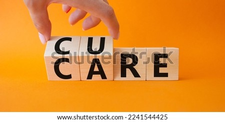 Cure and Care symbol. Businessman hand turnes wooden cubes and changes words Care to Cure. Beautiful orange background. Business and cure and care concept. Copy space
