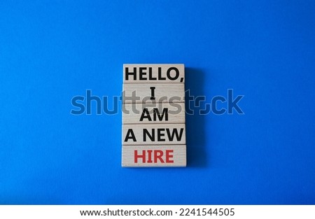 Hello I am a new hire symbol. Concept words Hello I am a new hire on wooden blocks. Beautiful blue background. Business and Hello I am a new hire concept. Copy space.