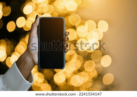 Merry Christmas and Happy Holidays! Close up  smartphone blank screen advertising mobile application. Great App                               