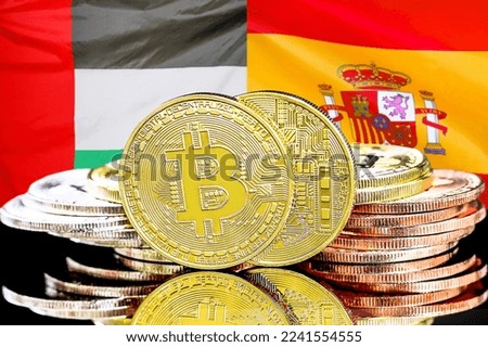 Bitcoins on flag of United Arab Emirates and Spain flag background. Concept for investors in cryptocurrency and Blockchain technology in UAE and Spain
