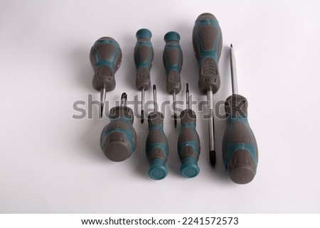 photo set of screwdrivers lying next to each other on a white background