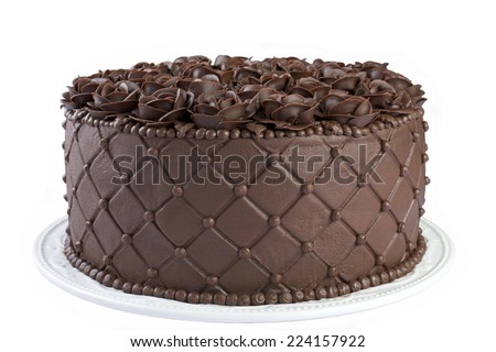 Triple Chocolate Cake frosted and embossed with diamond impression on the sides with hand crafted Chocolate frosting roses on top Isolated on White Background