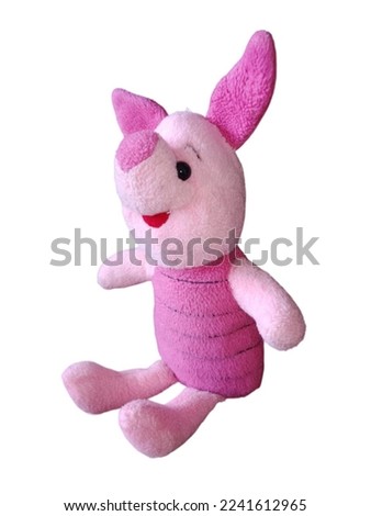 Cute little piglet doll sitting on a white background.