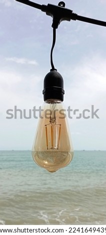 Light bulbs on the beach, Light bulbs hanging on the beach, Lights that turn off during the day