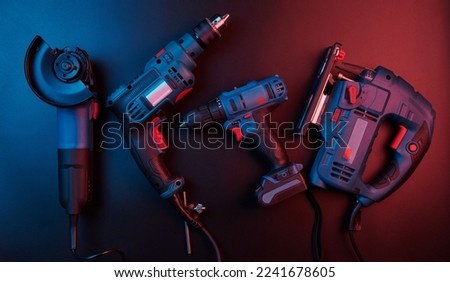 Set of new power tools isolated on a black background, drill, puncher, electric saw, jigsaw, circular saw Royalty-Free Stock Photo #2241678605