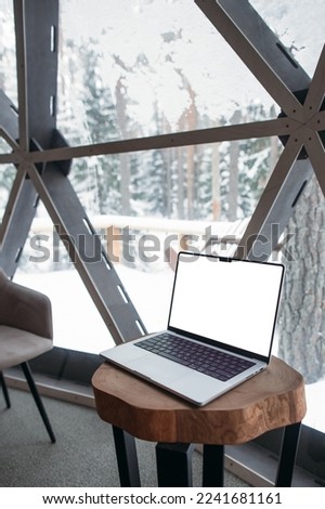 laptop on the table with space. winter outside the window