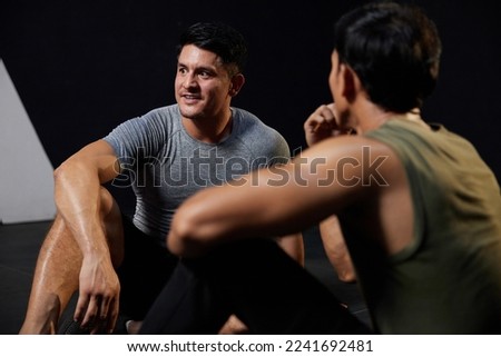 young athletic man taking a break after workout in the gym Royalty-Free Stock Photo #2241692481
