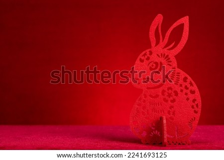 Chinese New Year of Rabbit mascot paper cut on red with copy space at horizontal composition no logo no trademark