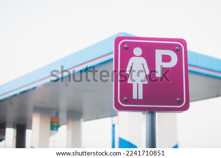 Lady parking sign at the oil station