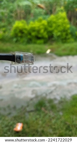 Human hand holding internet cable on blure background