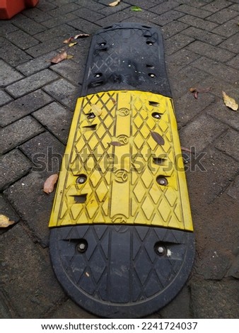 Black yellow Speed Bump on paving block