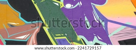 Colorful background of graffiti painting artwork with bright aerosol strips on metal wall. Old school street art piece made with aerosol spray paint cans. Contemporary youth culture backdrop Royalty-Free Stock Photo #2241729157