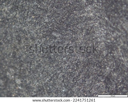 Structure of titanium under a microscope. The surface of the titanium alloy sample. Nanotubes on the surface. Metal surface treatment. Coating on titanium. Royalty-Free Stock Photo #2241751261