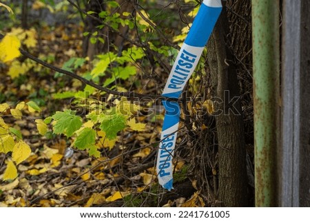 Broken police barrier tape with Politsei word (Police in Estonian) in Tallinn at the old scene of a crime. Estonia.