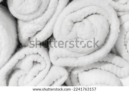 Set of soft white knitted light woolen fabric cotton bright blankets vintage background, close-up.