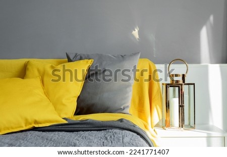 Color pillows illuminating ultimate gray pile on bed Two trendy 2021 colors of years Modern interior design bedroom textile Royalty-Free Stock Photo #2241771407