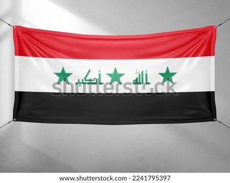 Iraq national flag cloth fabric waving on beautiful grey sky.