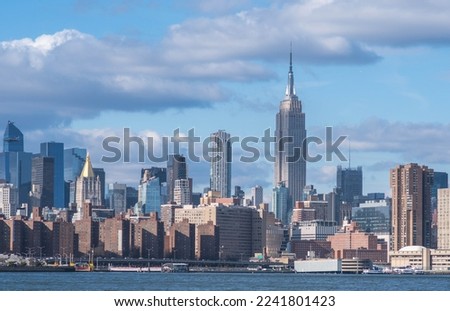 NYC Manhattan skyline in perfect day light clouds sky