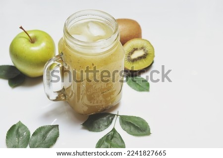 Healthy green smoothie and ingredients on white -  apple and kiwi. Superfood, detox and healthy food.