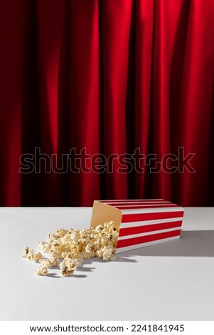 Popcorn on a theater stage with red curtains