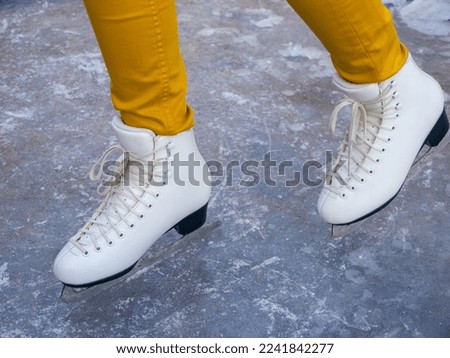 Girl in skates on ice.  Winter holidays.