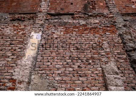 A wide angle photo of old red brick wall, column parts remained from a building can be used as texture, wallpaper, pattern or background