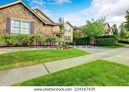 Clapboard siding house exterior with stone trim and beautiful curb appeal