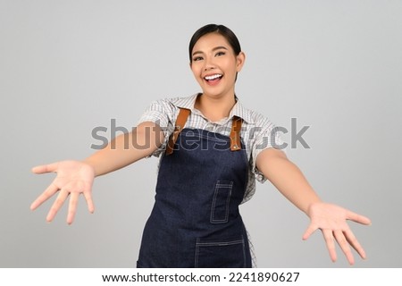 Portrait Asian young woman in waitress uniform with open palm posture, she smile and looking to camera with happy, Free space to insert product for advertising, isolated on white background
