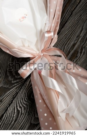 Elements of marshmallow bouquet. Ribbons and company labels. Packed in paper in the form of a bouquet. Close-up.
