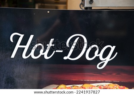 hot-dog fast food restaurant text sign on wall facade entrance in street