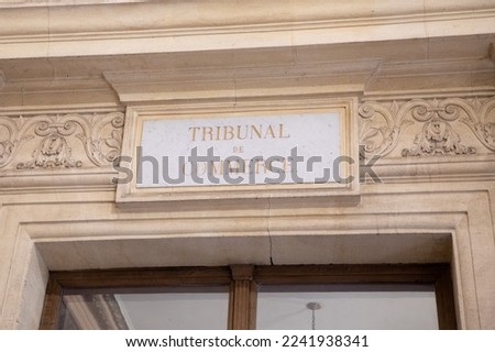 tribunal de commerce text on ancient wall facade building means in french the Commercial Court courthouse justice  Royalty-Free Stock Photo #2241938341