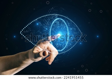 Close up of businessman hand pointing at glowing digital polygonal eye on dark background. Digital revolution concept